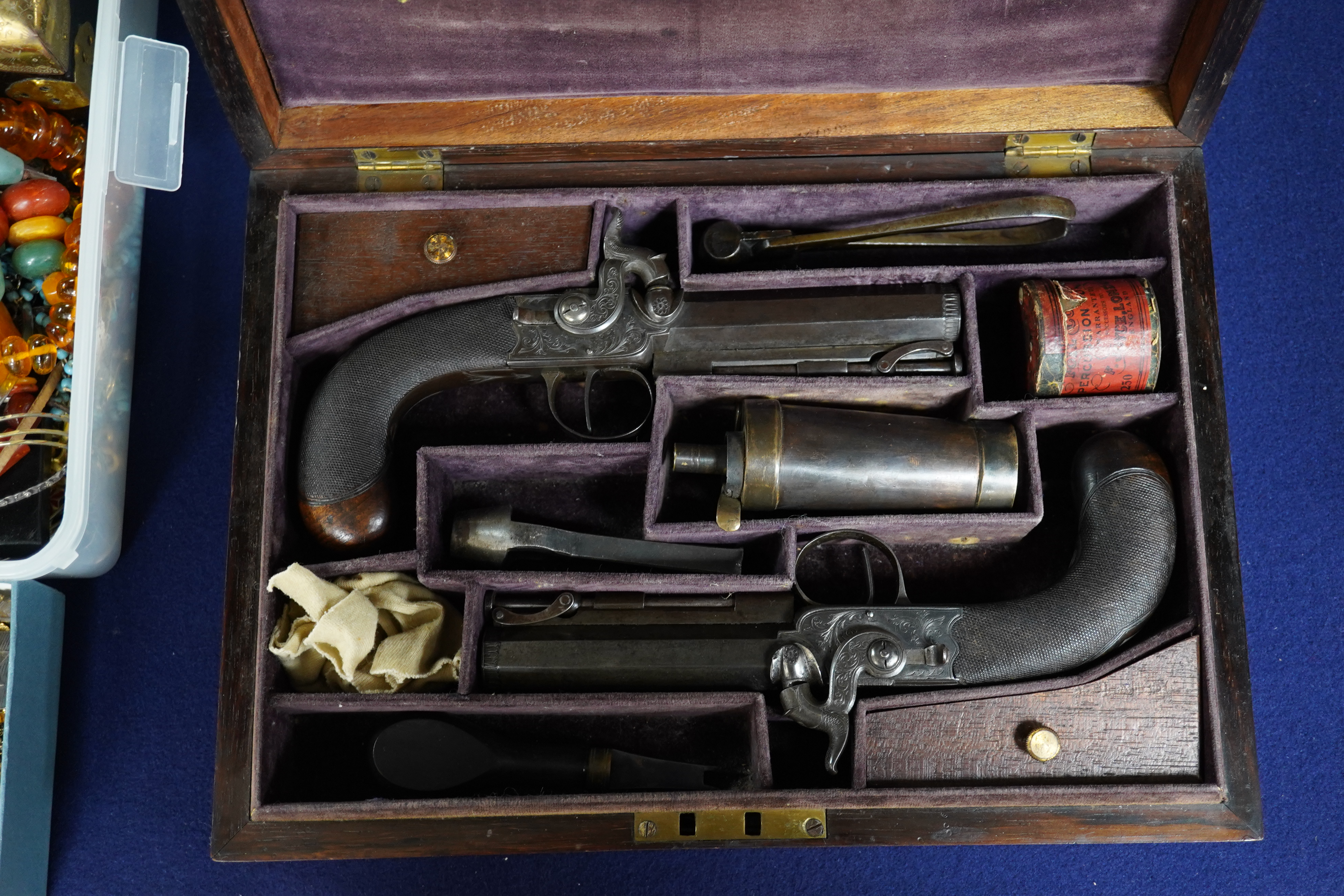 A pair of rosewood cased Blake & Co. London percussion cap travelling pistols, with octagonal barrels, engraved Blake & Co. London, Birmingham proof marks, side hammers, sliding safety bolts, swivel ramrods, foliate engr